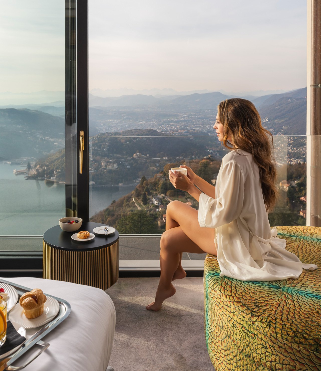 A guest enjoying coffee with views across Lake Como